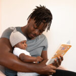 parent reading to a baby